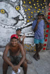 Residents of Brazilian artist Bel Borba’s hometown, Salvador de Bahia, with his artwork, as seen in BEL BORBA AQUI, directed by Burt Sun and André Costantini, with his work. Courtesy of Abramorama.